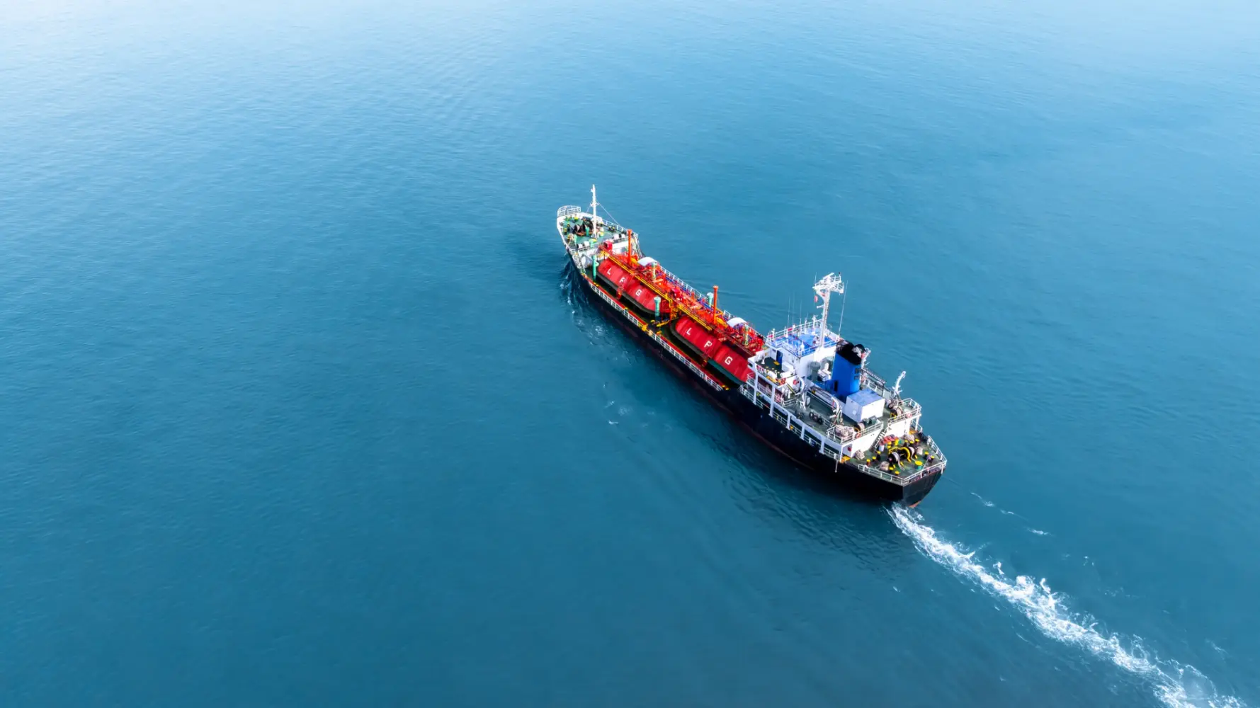 Aerial view of an LPG gas tanker ship navigating deep blue ocean waters