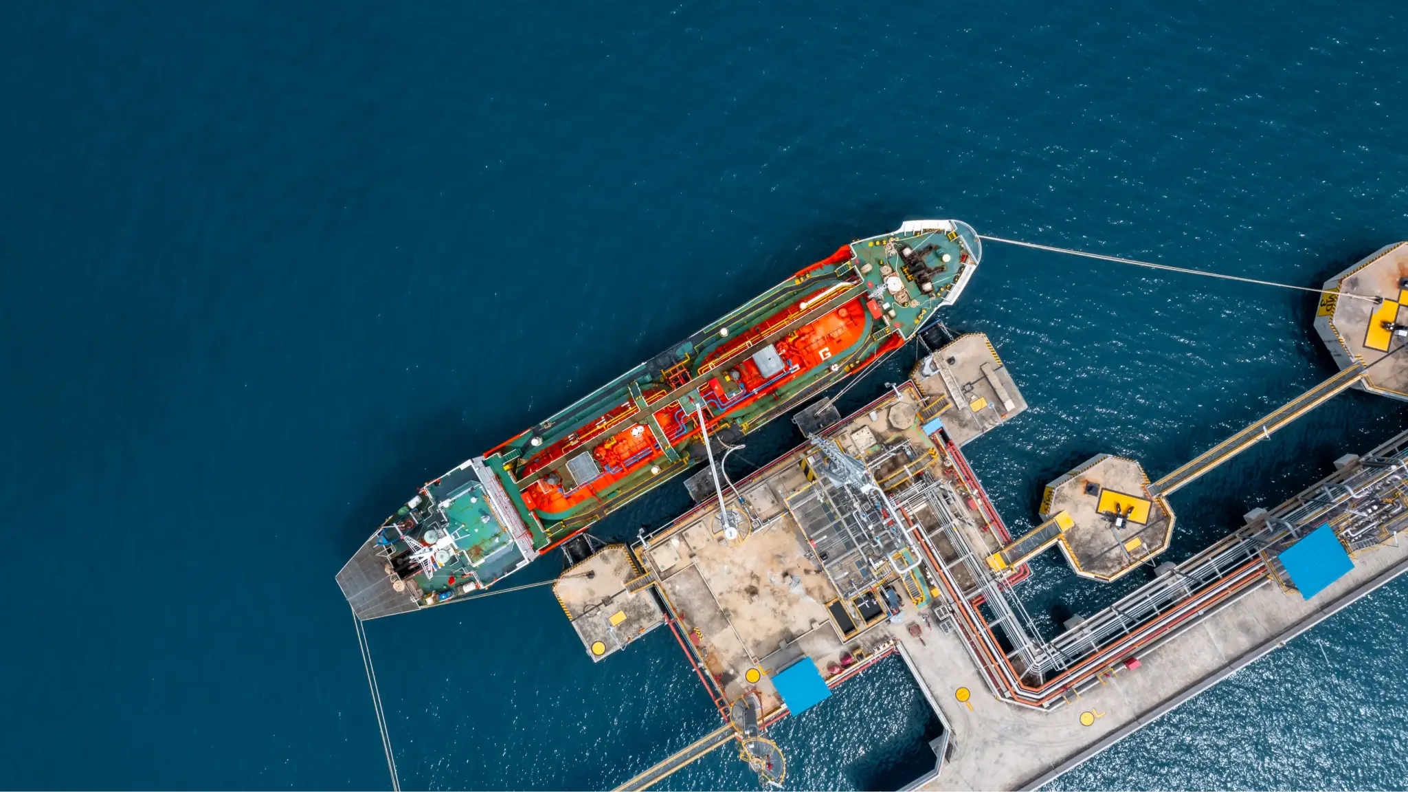 Aerial view of an LPG tanker ship berthed at a coastal depot terminal